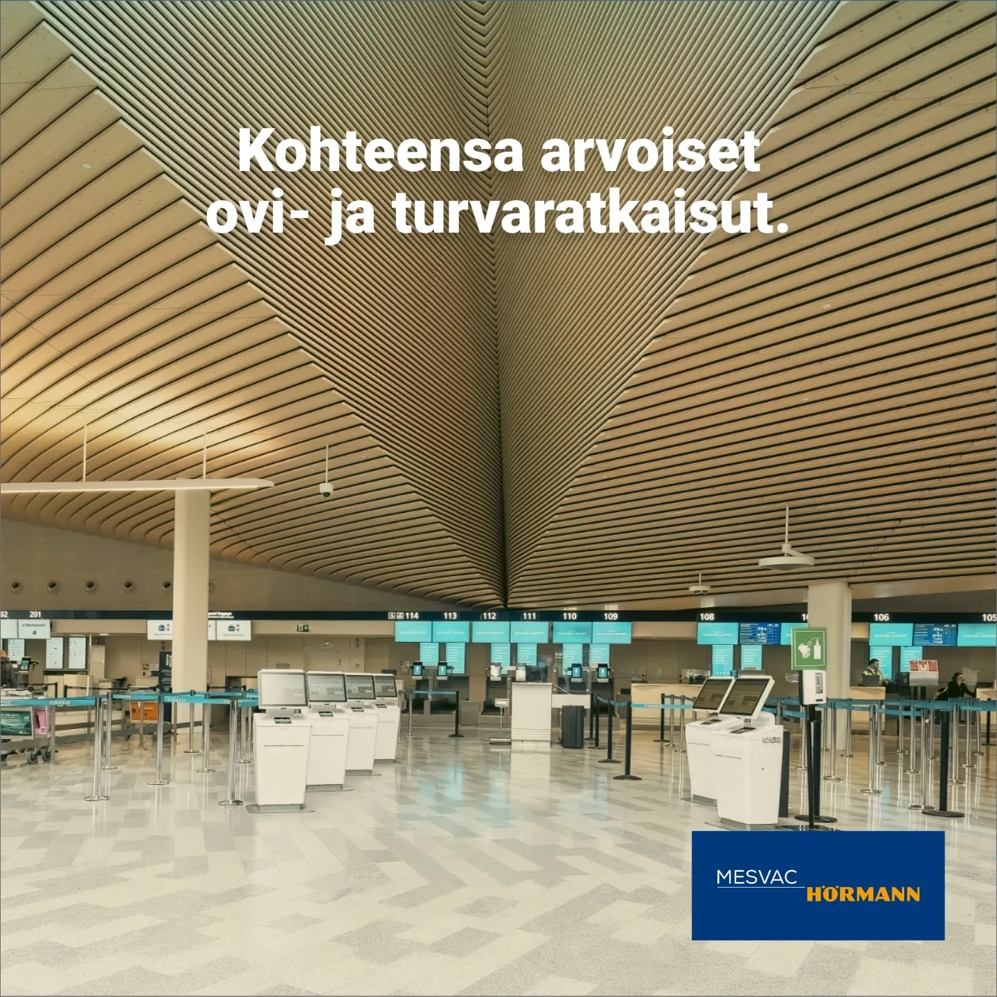 The wooden roof structure and check-in desks of the departure hall at Helsinki Airport, with the ad line Door and safety solutions worthy of their site
